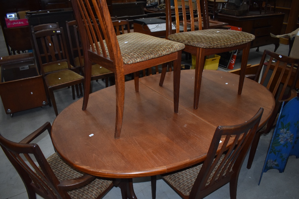A vintage teak G plan (whale tail design) extending dining table and six (four plus two) chairs