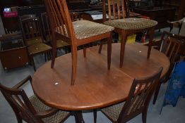 A vintage teak G plan (whale tail design) extending dining table and six (four plus two) chairs