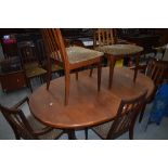 A vintage teak G plan (whale tail design) extending dining table and six (four plus two) chairs