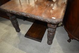 A 19th oak windout dining table with one additional leave (no winder) carved edge and legs