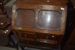 An early 20th Century oak bureau having Jacobean style flap and drawers, on twist legs, no key but