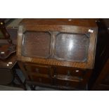 An early 20th Century oak bureau having Jacobean style flap and drawers, on twist legs, no key but