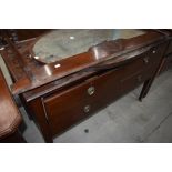 An early 20th Century mahogany chest of drawers, with rail and mirror to convert back to dressing