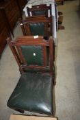 A set of three Victorian mahogany chairs having green leather seats and backs, possibly from a