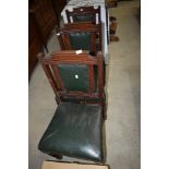 A set of three Victorian mahogany chairs having green leather seats and backs, possibly from a