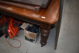 A 19th Century mahogany wind out dining table in the Gillows style, having heavy turned and fluted