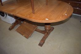 A vintage oak refectory style oval extending dining table