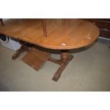 A vintage oak refectory style oval extending dining table
