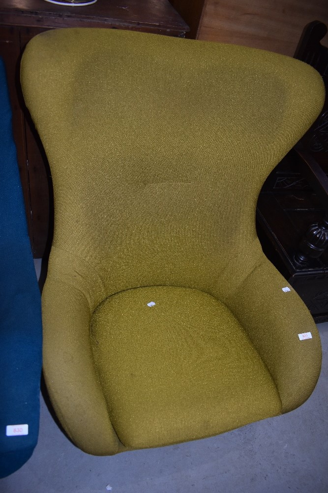 A vintage Eames style easy chair having teak frame and ochre upholstery