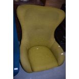 A vintage Eames style easy chair having teak frame and ochre upholstery