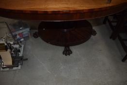 An early 19th century possibly William IV dining table of oval form on tilt top having mahogany