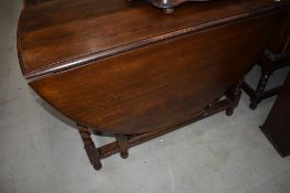 An early 20th Century oak twist gateleg dining table