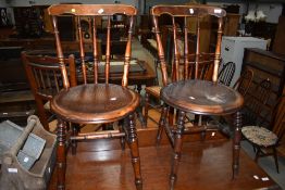 A pair of late Victorian dining chairs having patterned ply seats and turned frames, one seat