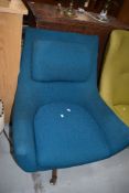 A vintage Eames style easy chair having teak frame and teal upholstery