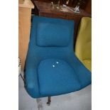 A vintage Eames style easy chair having teak frame and teal upholstery