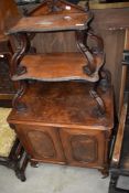 A Victorian mahogany side cabinet having whatnot style shaped shelf top with double cupboard