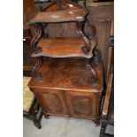 A Victorian mahogany side cabinet having whatnot style shaped shelf top with double cupboard