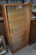 A vintage golden oak glazed bookcase, single piece double height