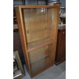 A vintage golden oak glazed bookcase, single piece double height