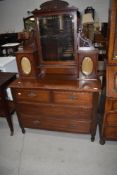 A Victorian mahogany dressing table having curtained glaze trinket cupboards and two over two drawer