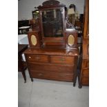 A Victorian mahogany dressing table having curtained glaze trinket cupboards and two over two drawer