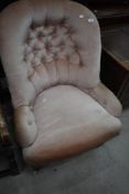 A Victorian mahogany frame nursing chair having button back and pink dralon upholstery