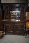 A 19th Century oak mirror back sideboard in typical ostentatious design with naturalistic and