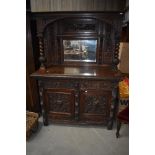 A 19th Century oak mirror back sideboard in typical ostentatious design with naturalistic and