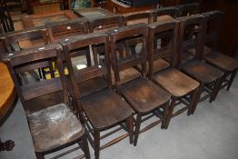 A selection of twelve traditional style chapel chairs with solid seats, hymn and turned frame , most