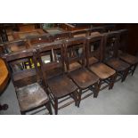 A selection of twelve traditional style chapel chairs with solid seats, hymn and turned frame , most