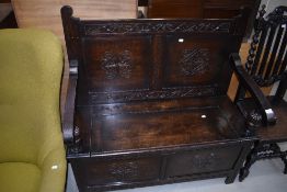 An early 20th Century oak carved box settle , labelled internally for J Snowden and Co, Morecambe