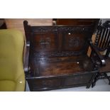 An early 20th Century oak carved box settle , labelled internally for J Snowden and Co, Morecambe