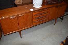 A vintage teak sideboard, in the Long John style G Plan or similar having four central drawers