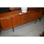 A vintage teak sideboard, in the Long John style G Plan or similar having four central drawers