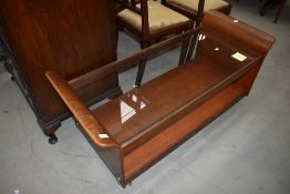 A vintage teak and bent ply coffee table/trolley with glass top, width approx. 122cm