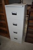 A modern metal four drawer filing cabinet