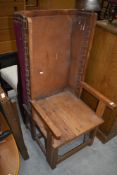 A golden oak and leather Arts and Crafts carver chair, in the Orkney style