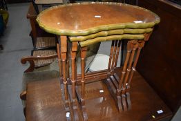 A reproduction nest of three shaped top tables in the period style