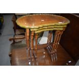 A reproduction nest of three shaped top tables in the period style