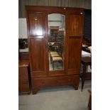 An Edwardian mahogany and inlaid mirror door wardobe on drawer base