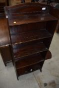 An early 20th Century mahogany narrow bookshelf and an oak shelf with brass hooks attached