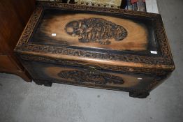 A traditional Oriental carved camphor wood bedding or similar chest, width approx. 90cm