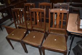 A set of six oak rail back dining chairs having drop in dralon seats