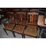 A set of six oak rail back dining chairs having drop in dralon seats