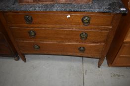 A late Victorian oak washstand having marble top and Arts and Crafts style handles, width approx.