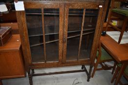 An early 20yh Century bookcase on barley twist legs, width approx. 106cm