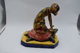 A reproduction Majolika style study, Monkey riding Turtle on ceramic base