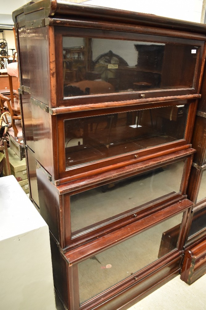 An early 20th Century mahogany and stained frame stacking bookcase unit base having four glazed