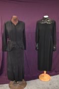 Two black dresses, one 1940s peplum dress having CC41 utility label, and earlier black dress with