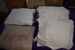 A selection of of beautifully embroidered pyjama cases,some with cut work and other intricate